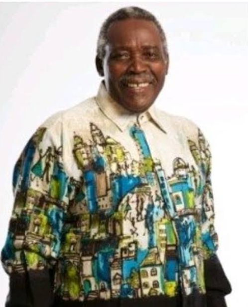 Olu Jacobs smiling in a multicoloured shirt